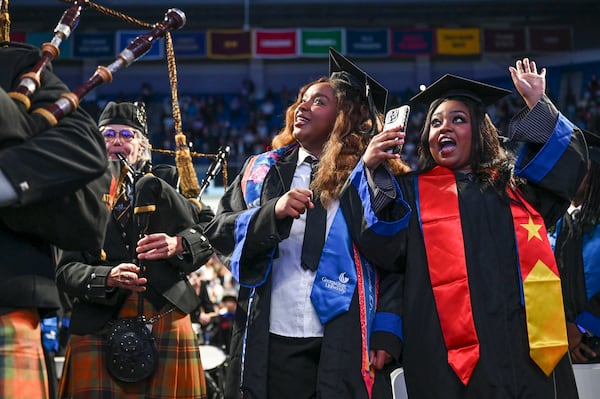 Kamala Pierre-Paul (left) and Sable Psegay are all smiles at the start of Georgia State University’s Spring commencement ceremony for College of Arts & Sciences Wednesday, May 7, 2025 in Atlanta. (Daniel Varnado/For the Atlanta Journal-Constitution)