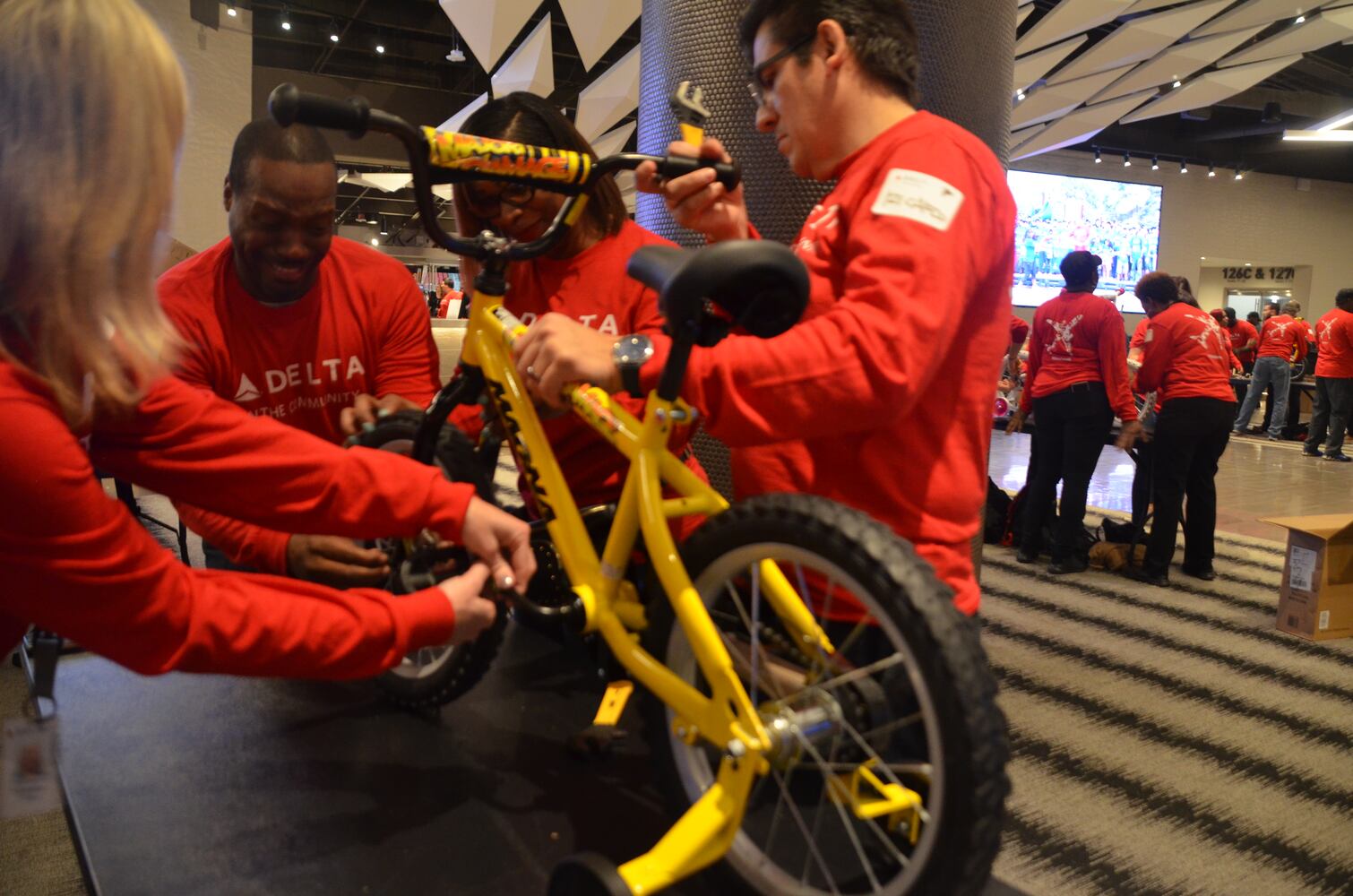 Delta volunteers assemble 100 bicycles to donate to kids