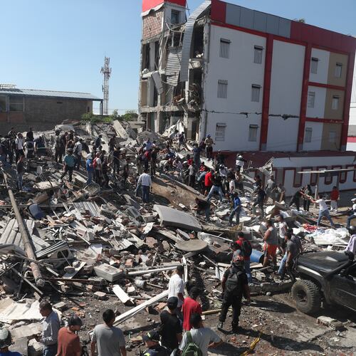Residents and rescue workers search through the rubble of a collapsed building after an earthquake struck Cali, Colombia, Monday, Aug. 10, 2026. (AP Photo/Santiago Saldarriaga)