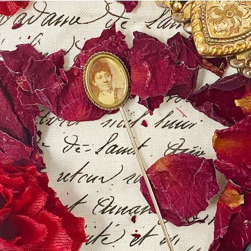 An antique Victorian era oval photographic stickpin featuring an unidentified elegant Black woman, c. 1885-1910.