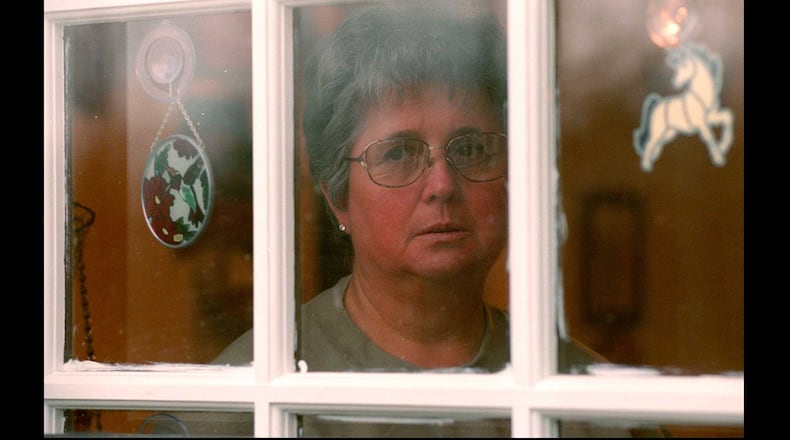 From 1999: Mary Stoner looks out the kitchen window of her home in Adairsville, toward the grave of her daughter Mary Frances Stoner, who is buried out behind the house and up on a hill. Mary Frances was raped and murdered when she was 12 years old old, which at that point was 20 years ago.