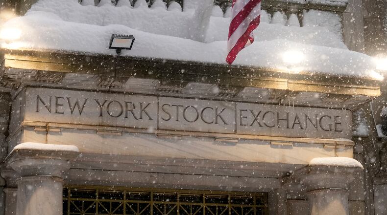 Snow falls outside the New York Stock Exchange, Monday, Feb. 23, 2026, in New York. (AP Photo/Seth Wenig)