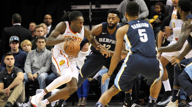Atlanta Hawks forward Taurean Prince, left, drives against Memphis Grizzlies guard Tyreke Evans (12) in the first half of an NBA basketball game Friday, Dec. 15, 2017, in Memphis, Tenn. (AP Photo/Brandon Dill)