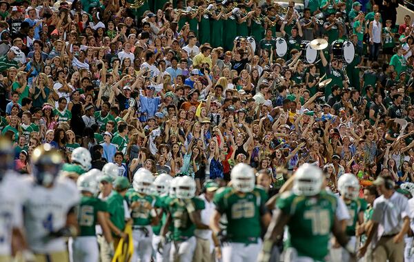Buford fans celebrate the 27-20 win over McEachern last season in Buford. (Jason Getz / Special to AJC)