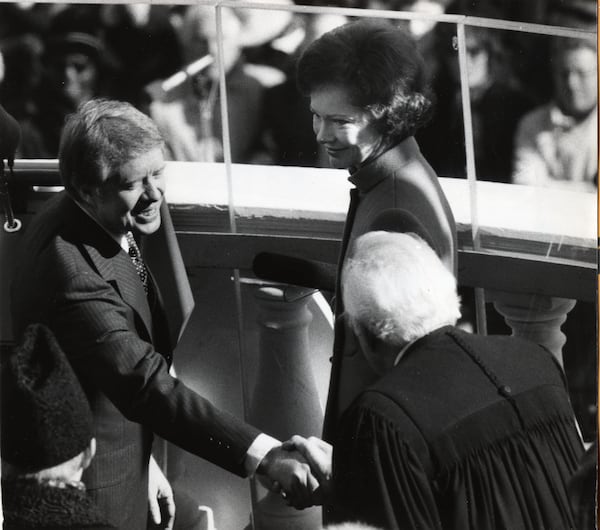 Rosalynn Carter watches as Jimmy Carter shakes hands with Chief Justice Warren Burger at the Jan. 20, 1977, presidential inauguration. Burger had just administered the presidential oath of office to the new 39th president. Rosalynn Carter died in 2023 at age 96. Justice Burger died in 1995.
