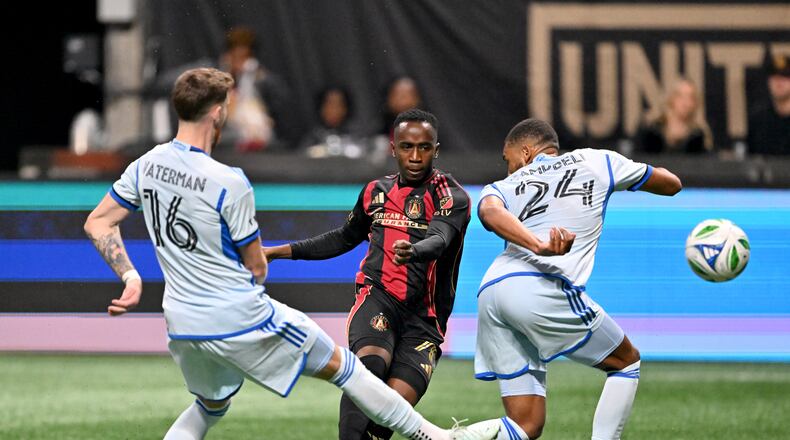 Atlanta United forward Edwin Mosquera (70) makes the game winning shot as CF Montreal defender George Campbell (24) and CF Montreal defender Joel Waterman (16) defense during the second half of Atlanta United’s MLS season opener at Mercedes-Benz Stadium, Saturday, February 22, 2025, in Atlanta. Atlanta United won 3-2 over CF Montreal. (Hyosub Shin / AJC)