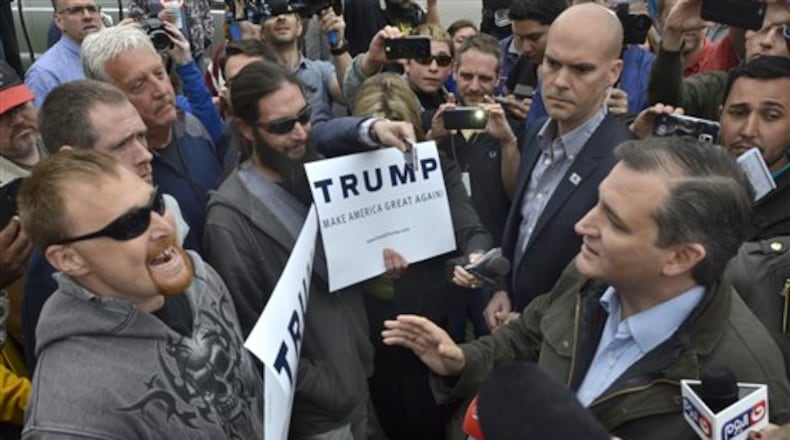 Republican presidential candidate Ted Cruz, right, exchanges words with Donald Trump supporters during a campaign visit to Marion, Ind., on Monday, May 2, 2016. (Jeff Morehead/Chronicle-Tribune via AP)