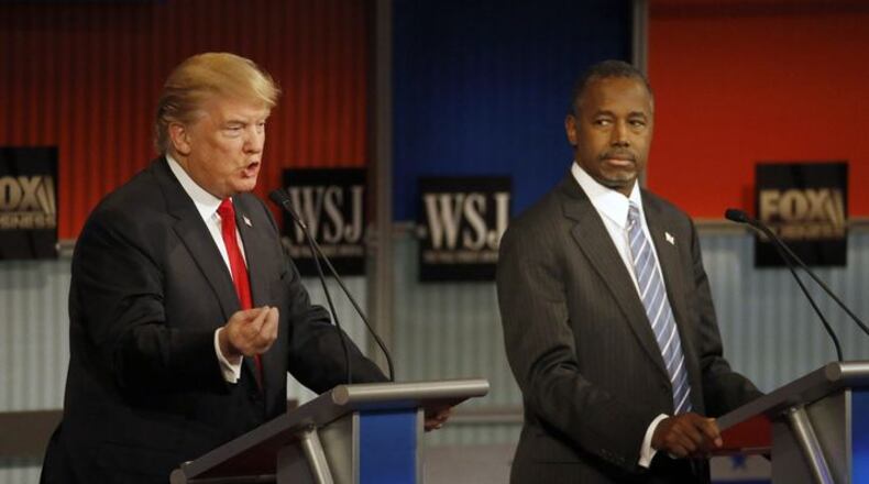 Ben Carson listens as Donald Trump speaks during Tuesday night's debate. I still don't think either of them will be the GOP nominee. (AP Photo / Morry Gash)
