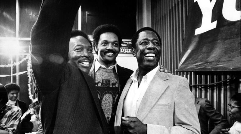 Reginald Eaves, Jesse Jackson and Hank Aaron at Andrew Young's campaign headquarters after Young’s election as mayor in October 1981. AJC file
