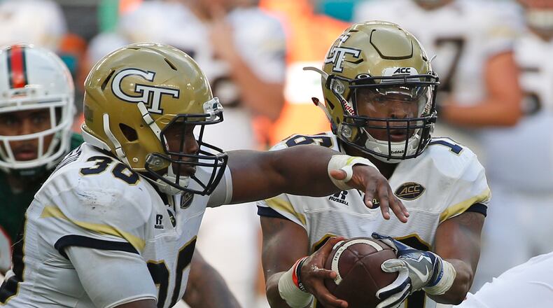 Jackets QB TaQuon Marshall fakes a handoff to KirVonte Benson (30) during the first half of Saturday's game. (AP Photo/Wilfredo Lee)