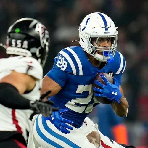 Indianapolis Colts running back Jonathan Taylor (28) runs from Atlanta Falcons linebacker Kaden Elliss (55) during the first half of an NFL football game, Sunday, Nov. 9, 2025, in Berlin, Germany. (AP Photo/Ebrahim Noorozi)