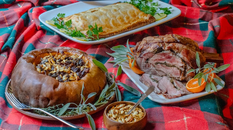For a show-stopping holiday entree that doesn't break the bank, prepare (from left) Vegan Stuffed Roast Pumpkin, Salmon en Croute or Pork Shoulder Porchetta.  (Virginia Willis for The Atlanta Journal-Constitution)
