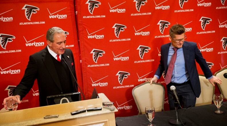 Atlanta Falcons owner Arthur Blank, left, and general manager Thomas Dimitroff leave a news conference after announcing that Mike Smith has been fired as head coach, Monday, Dec. 29, 2014, in Atlanta. (AP Photo/David Goldman) Are they playing musical chairs in Flowery Branch? (David Goldman/AP photo)
