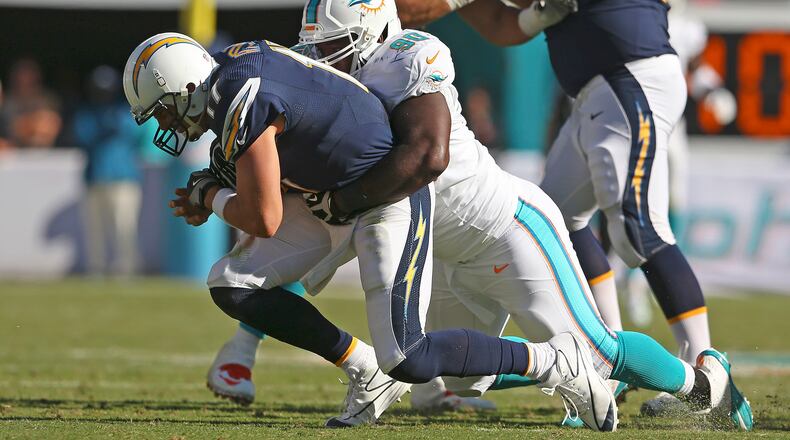 Quarterback Philip Rivers #17 of the San Diego Chargers is sacked by defensive tackle Earl Mitchell #90 of the Miami Dolphins in the third quarter during a game at Sun Life Stadium on November 2, 2014 in Miami Gardens, Florida.  (Photo by Mike Ehrmann/Getty Images)