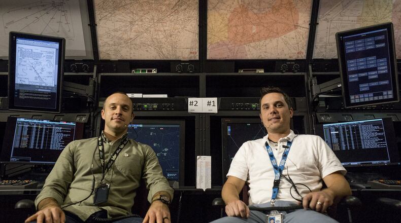 Air traffic control specialists James Hossenlopp, 36, (left) and Jason Harvey, 35, pose for a portrait in the Testing and Training Lab at the Atlanta Air Route Traffic Control Center in Hampton, Georgia, on Friday, Oct. 27, 2017. (CASEY SYKES / CASEY.SYKES@AJC.COM)