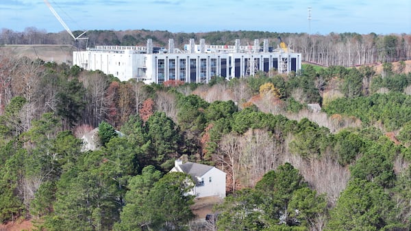 The Microsoft data center in the background sits near residential areas in Union City on Wednesday, Dec. 3, 2025. The project, developed by EdgeConnex, was supported by a tax break from the Development Authority of Fulton County. (Miguel Martinez/AJC)