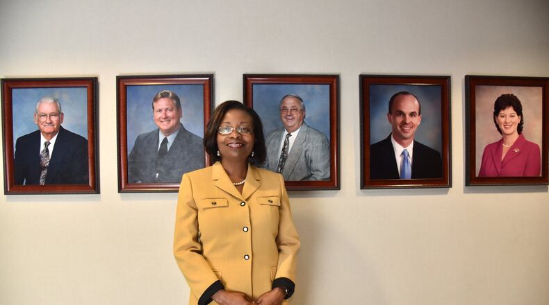 Portrait of Incoming Henry County Commission Chairman June Wood in front of photographs of previous chairs of the Henry County Board of Commissioners. HYOSUB SHIN / HSHIN@AJC.COM