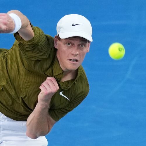 Jannik Sinner of Italy serves to his compatriot Luciano Darderi during their fourth round match at the Australian Open tennis championship in Melbourne, Australia, Monday, Jan. 26, 2026. (AP Photo/Aaron Favila)