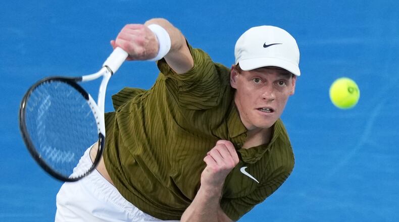 Jannik Sinner of Italy serves to his compatriot Luciano Darderi during their fourth round match at the Australian Open tennis championship in Melbourne, Australia, Monday, Jan. 26, 2026. (AP Photo/Aaron Favila)