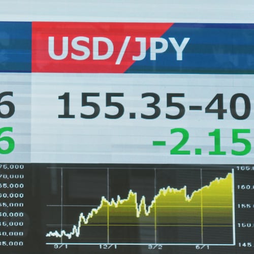A person walks past an electronic board showing the U.S. dollar and Japanese yen exchange rate at a securities firm in Tokyo on Monday, Aug. 3, 2026. (AP Photo/Eugene Hoshiko)
