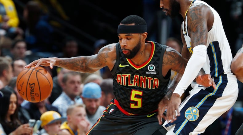 Atlanta Hawks guard Malcolm Delaney, left, works the ball inside as Denver Nuggets guard Will Barton defends in the first half of an NBA basketball game Wednesday, Jan. 10, 2018 in Denver. (AP Photo/David Zalubowski)