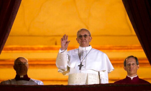 FILE - Argentine Cardinal Jorge Bergoglio, who chose the name of Pope Francis, waves to the crowd from the central balcony of St. Peter's Basilica after being elected 266th pontiff of the Roman Catholic Church, at the Vatican, Wednesday, March 13, 2013. (AP Photo/Gregorio Borgia, file)