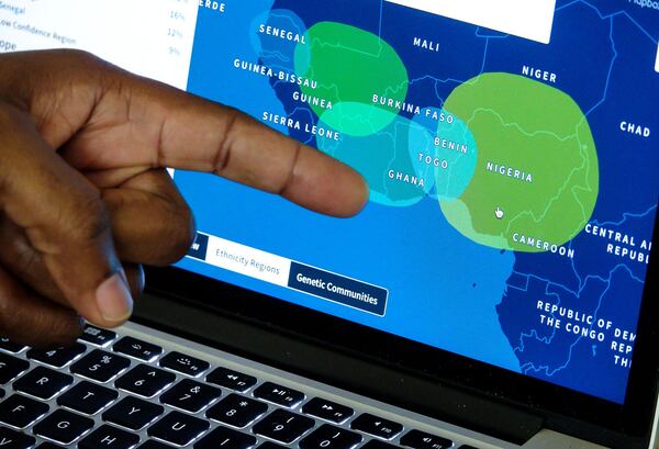 Palm Beach Post reporter Wayne Washington looks at his Ancestry.com results showing a concentration in western Africa at his home in Wellington on September 2, 2017. (Richard Graulich / The Palm Beach Post)
