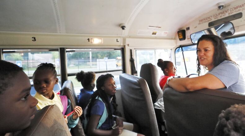 Atlanta Public Schools Superintendent Meria Carstarphen greets children on a school bus on Aug. 12, 2019, the first day of the school year. BOB ANDRES / ROBERT.ANDRES@AJC.COM