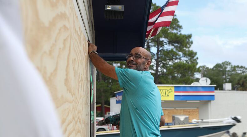 Akef Elkhatteeb in Carrabelle, Florida, boarding up the windows of the gas station in preparation for Hurricane Michael.