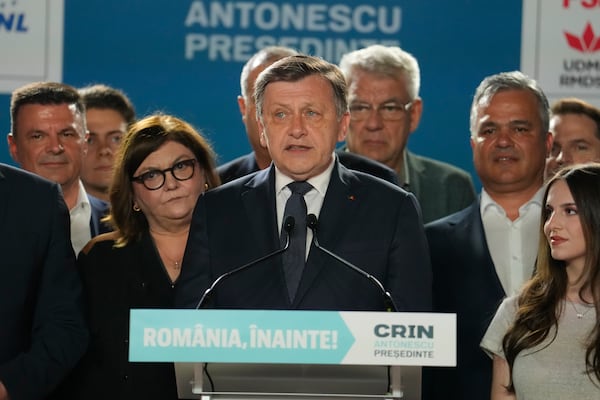 Presidential candidate Crin Antonescu, centre, attends a meeting with supporters after polls closed for the first round of the country's presidential election redo in Bucharest, Romania, Sunday, May 4, 2025. (AP Photo/Vadim Ghirda)