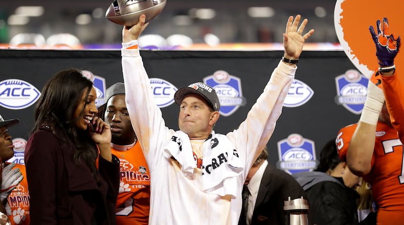 In what has become something of a routine for Dabo Swinney, the Clemson head coach raises the ACC Championship trophy after drubbing Miami. (Streeter Lecka/Getty Images)