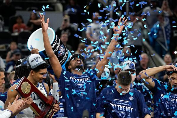 Villanova celebrates with the trophy after their win against Houston during a college basketball game in the Elite Eight round of the NCAA tournament on Saturday, March 26, 2022, in San Antonio. (AP Photo/David J. Phillip)