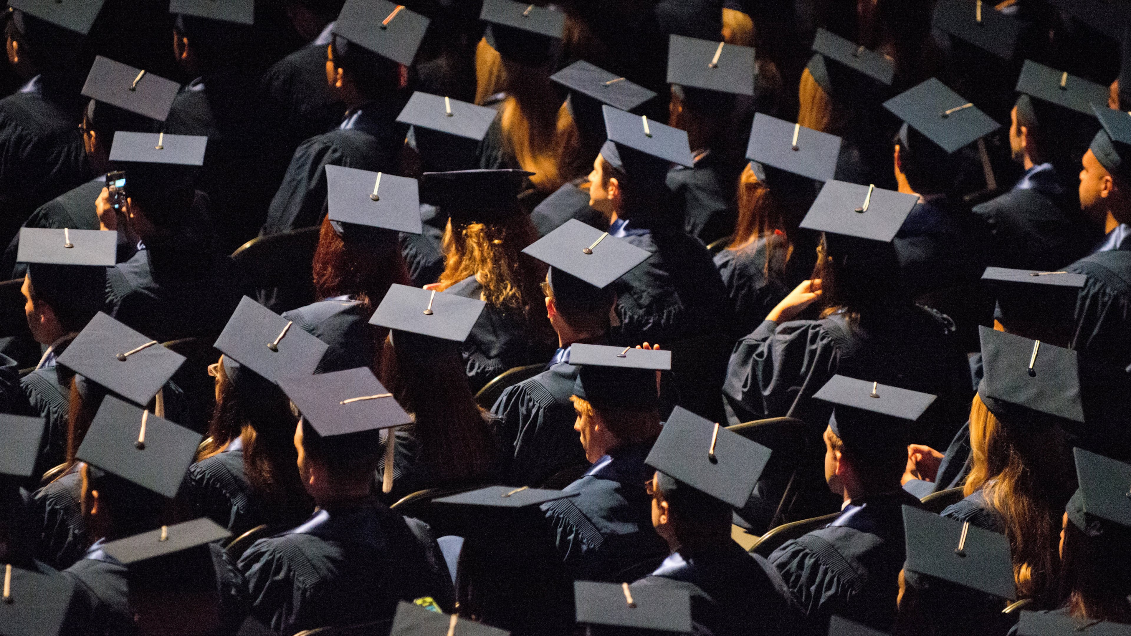 FILE - Students attend commencement ceremonies in the State Farm Center at the University of Illinois in Champaign, Ill., on Sunday, May 12, 2013. (Darrell Hoemann/The News-Gazette via AP, File)