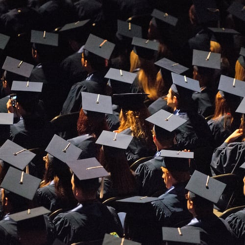 FILE - Students attend commencement ceremonies in the State Farm Center at the University of Illinois in Champaign, Ill., on Sunday, May 12, 2013. (Darrell Hoemann/The News-Gazette via AP, File)