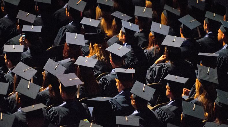 FILE - Students attend commencement ceremonies in the State Farm Center at the University of Illinois in Champaign, Ill., on Sunday, May 12, 2013. (Darrell Hoemann/The News-Gazette via AP, File)