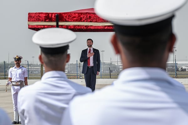 U.S. Vice President JD Vance places his hand over his heart as the American national anthem is played ahead of him reviewing troops upon his arrival in New Delhi, India, Monday, April 21, 2025. (Kenny Holston/The New York Times via AP, Pool)