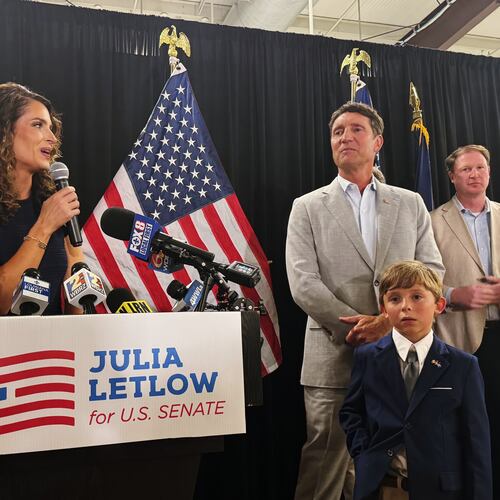 U.S. Rep. Julia Letlow, standing beside her fiancee Kevin Ainsworth, center right, and her son, addresses her supporters in Baton Rouge, La., Saturday, June 27, 2026, after winning the GOP Senate nomination. (AP Photo/Jack Brook)