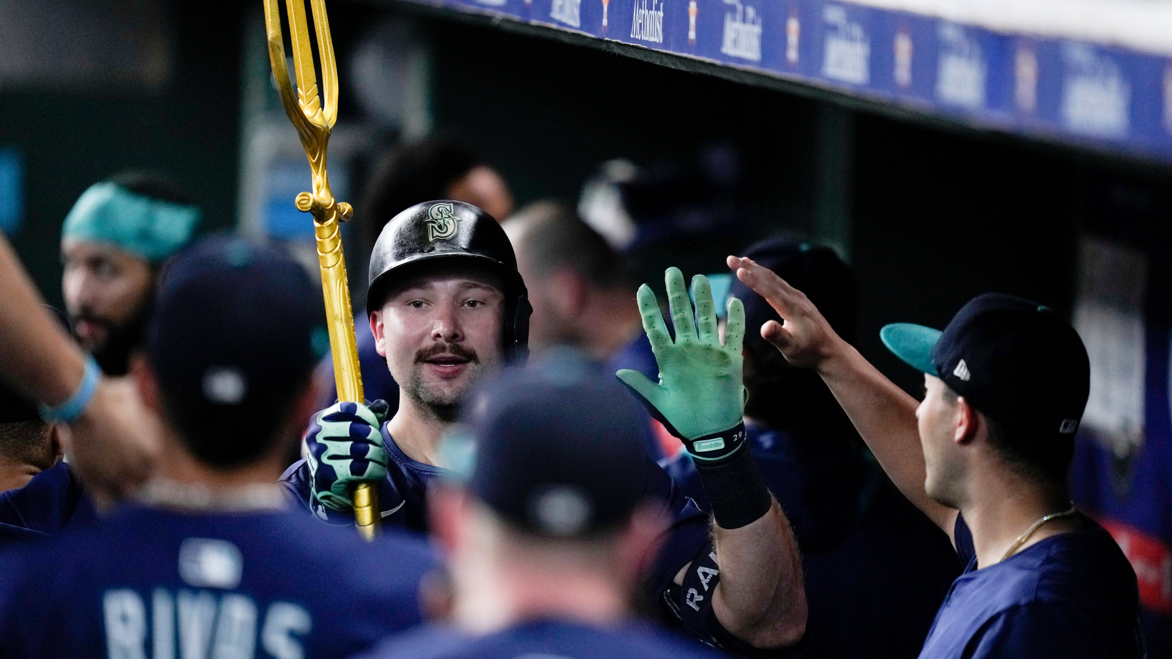 Seattle Mariners' Cal Raleigh carries a trident after hitting a solo home run, his 57th of the season, against the Houston Astros during the third inning of a baseball game Saturday, Sept. 20, 2025, in Houston. (AP Photo/Eric Christian Smith)