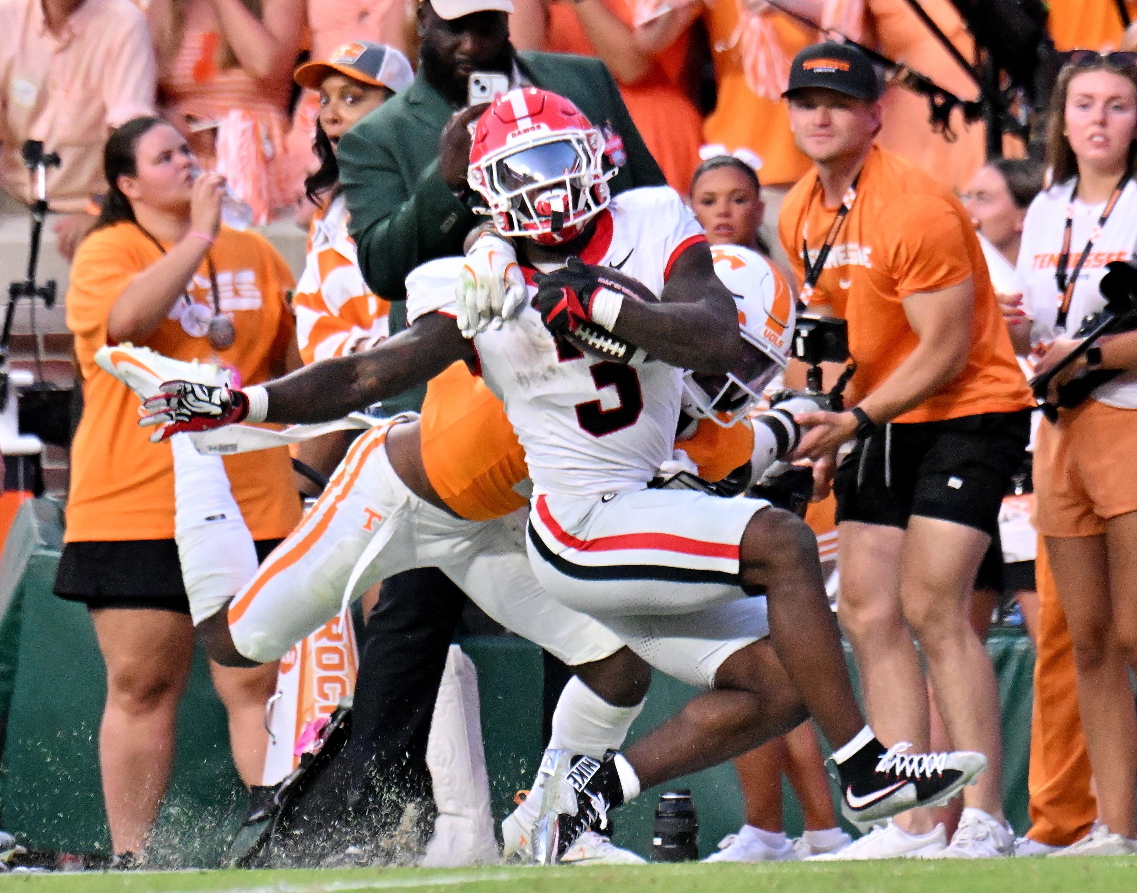 Georgia running back Nate Frazier (front) gets tackled by Tennessee defensive back Andre Turrentine near the end zone during overtime against Tennessee at Neyland Stadium on Saturday, Sept. 13, 2025, in Knoxville, Tenn. Georgia won 44-41 in overtime. (Hyosub Shin/AJC)