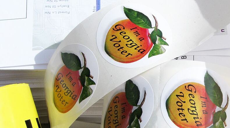 Georgia’s iconic election stickers are considered a badge of honor for many voters. (File Photo: AJC)