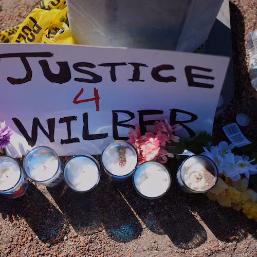Flowers and candles are seen near the site where a Venezuelan man was shot in his vehicle by an ICE officer in Austin, Texas, Monday, Sept. 21, 2026. (AP Photo/Eric Gay)
