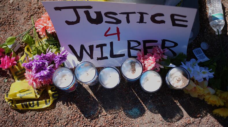 Flowers and candles are seen near the site where a Venezuelan man was shot in his vehicle by an ICE officer in Austin, Texas, Monday, Sept. 21, 2026. (AP Photo/Eric Gay)