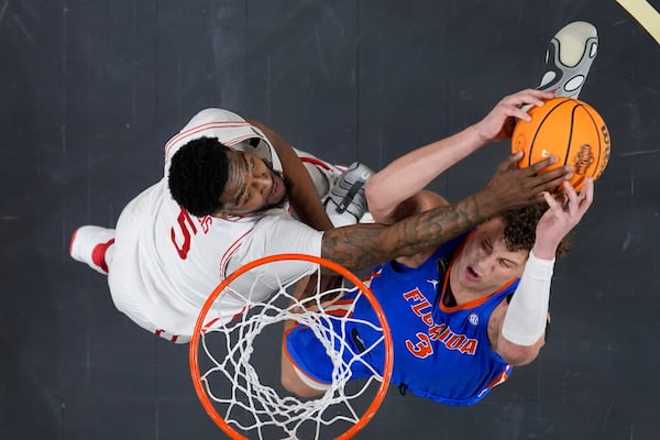 Houston forward Ja'Vier Francis blocks a shot by Florida center Micah Handlogten during the first half in the national championship at the Final Four of the NCAA college basketball tournament, Monday, April 7, 2025, in San Antonio. (AP Photo/Brynn Anderson)