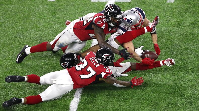 New England wide receiver Julian Edelman manages to make a 23-yard catch in the fourth quarter against three Falcons defenders -- Ricardo Allen (37), Robert Alford (23) and Keanu Neal (22).