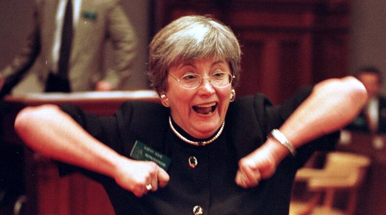 Rep. Kathy Ashe, R-Atlanta, does the 'Dirty Bird' on the floor of the state House in Atlanta on Friday, Jan. 15, 1999. Ashe suggested the legislature do the 'Dirty Bird' to wish the Falcons good luck in their NFC Championship matchup against the Minnesota Vikings. (AP Photo/Alan Mothner)