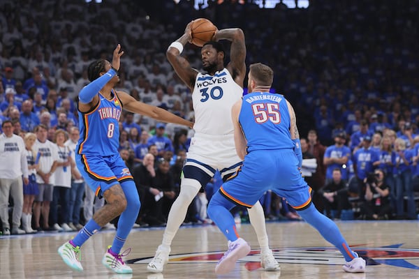 Minnesota Timberwolves forward Julius Randle (30) looks to pass as Oklahoma City Thunder forward Jalen Williams (8) and center Isaiah Hartenstein (55) defend during the first half of Game 5 of the Western Conference finals of the NBA basketball playoffs, Wednesday, May 28, 2025, in Oklahoma City. (AP Photo/Nate Billings)