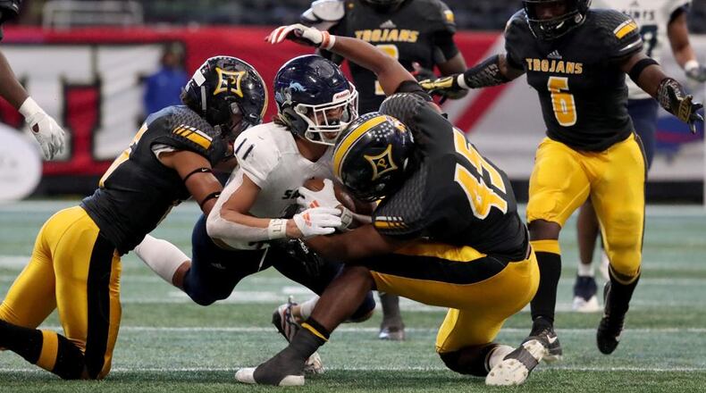 December 11, 2018 - Atlanta, Ga: Cedar Grove wide receiver Jadon Haselwood (11) is tackled by Peach County Daelan Smith, left, and Sergio Allen (45) after a catch by Haselwood in the first half of the Class AAA State Championship at Mercedes-Benz Stadium, Tuesday, December 11, 2018, in Atlanta. (JASON GETZ/SPECIAL TO THE AJC)
