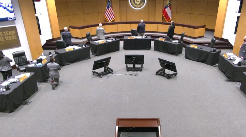 Cobb County School Board member Dr. Jaha Howard took a knee during the Pledge of Allegiance at the school board’s Oct. 15 meeting. Credit: screenshot from Cobb County School District