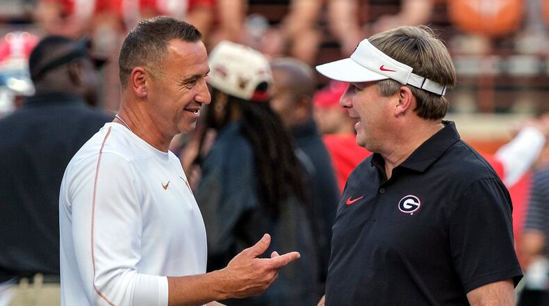 Texas coach Steve Sarkisian, left, and Georgia coach Kirby Smart talk during the pregame of an NCAA college football game in Austin, Texas, Saturday, Oct. 19, 2024. (AP Photo/Rodolfo Gonzalez)