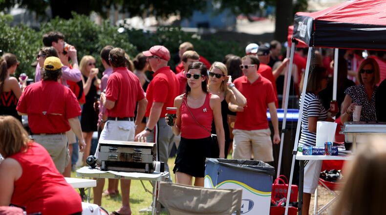 University of Georgia fans mingle as they tailgate off of South Lumpkin Street before a 2013 Georgia game. JASON GETZ / JGETZ@AJC.COM